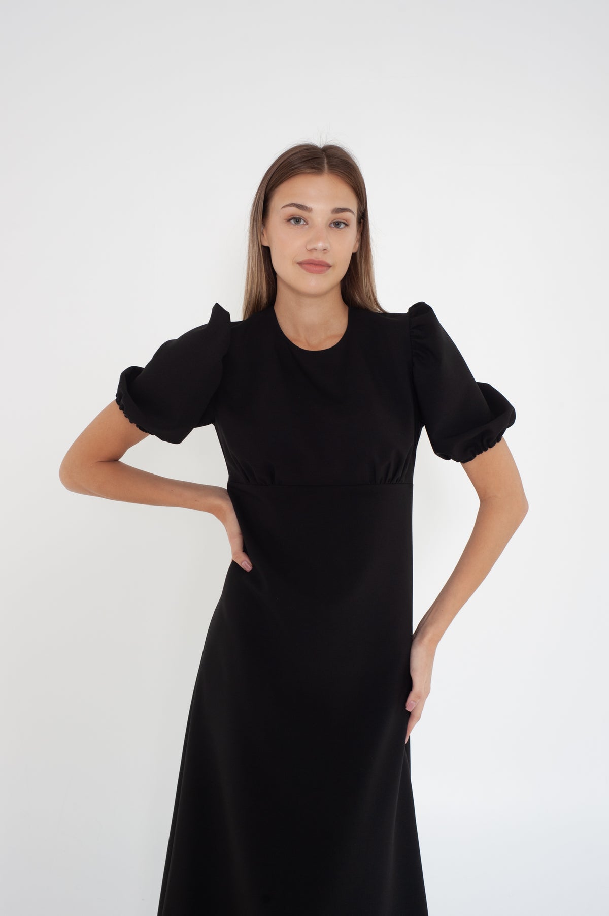 black midi dress with puff short sleeves from the front. Model wears size S.