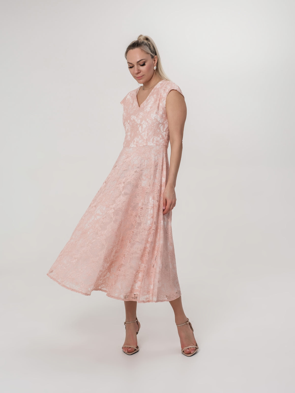 Soft pink lace dress with delicate sleeves and voluminous skirt