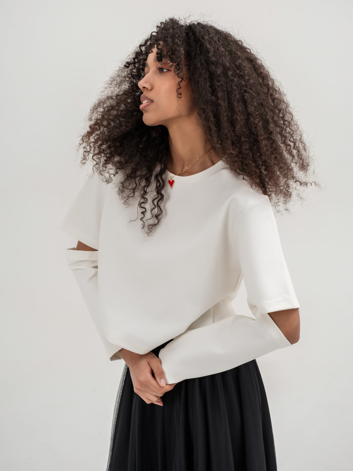 White top with slits in the elbow area