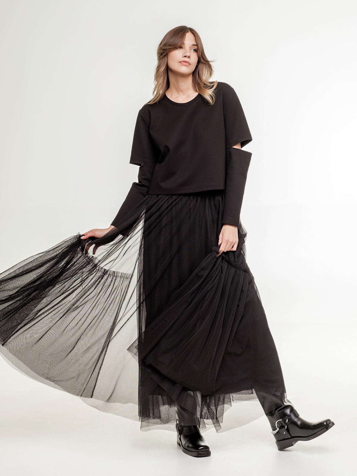 black long tulle skirt and black top with long sleeves and elbow cuts 