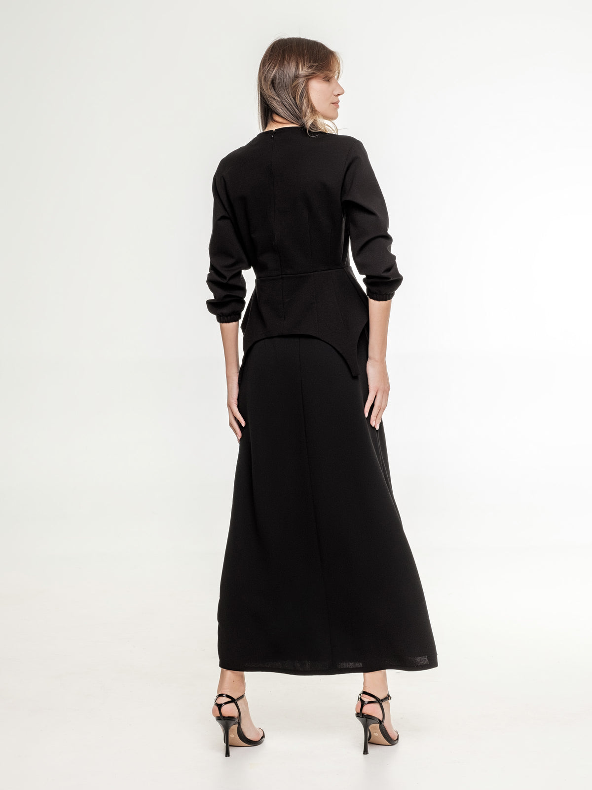 black set of top with long sleeves and long skirt from the back