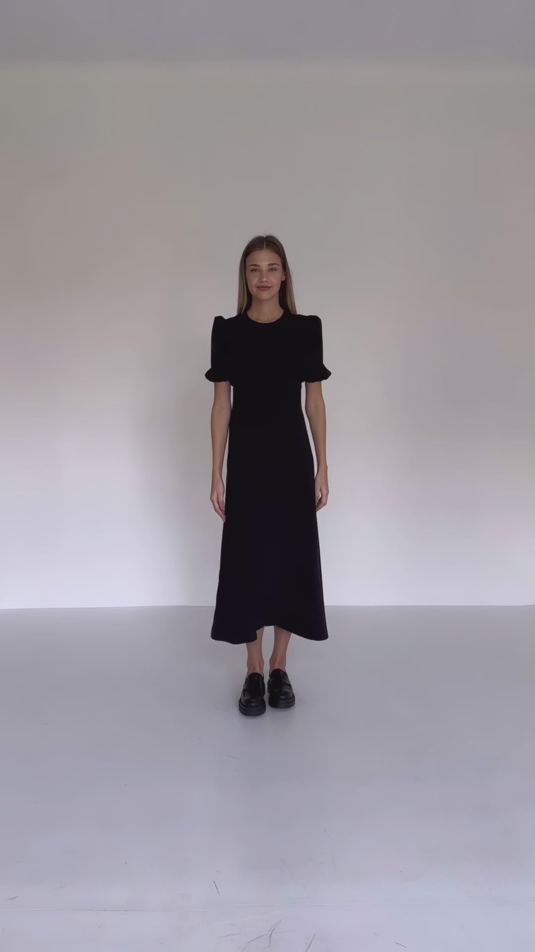 video featuring black midi dress with puff short sleeves. Model wears size S.