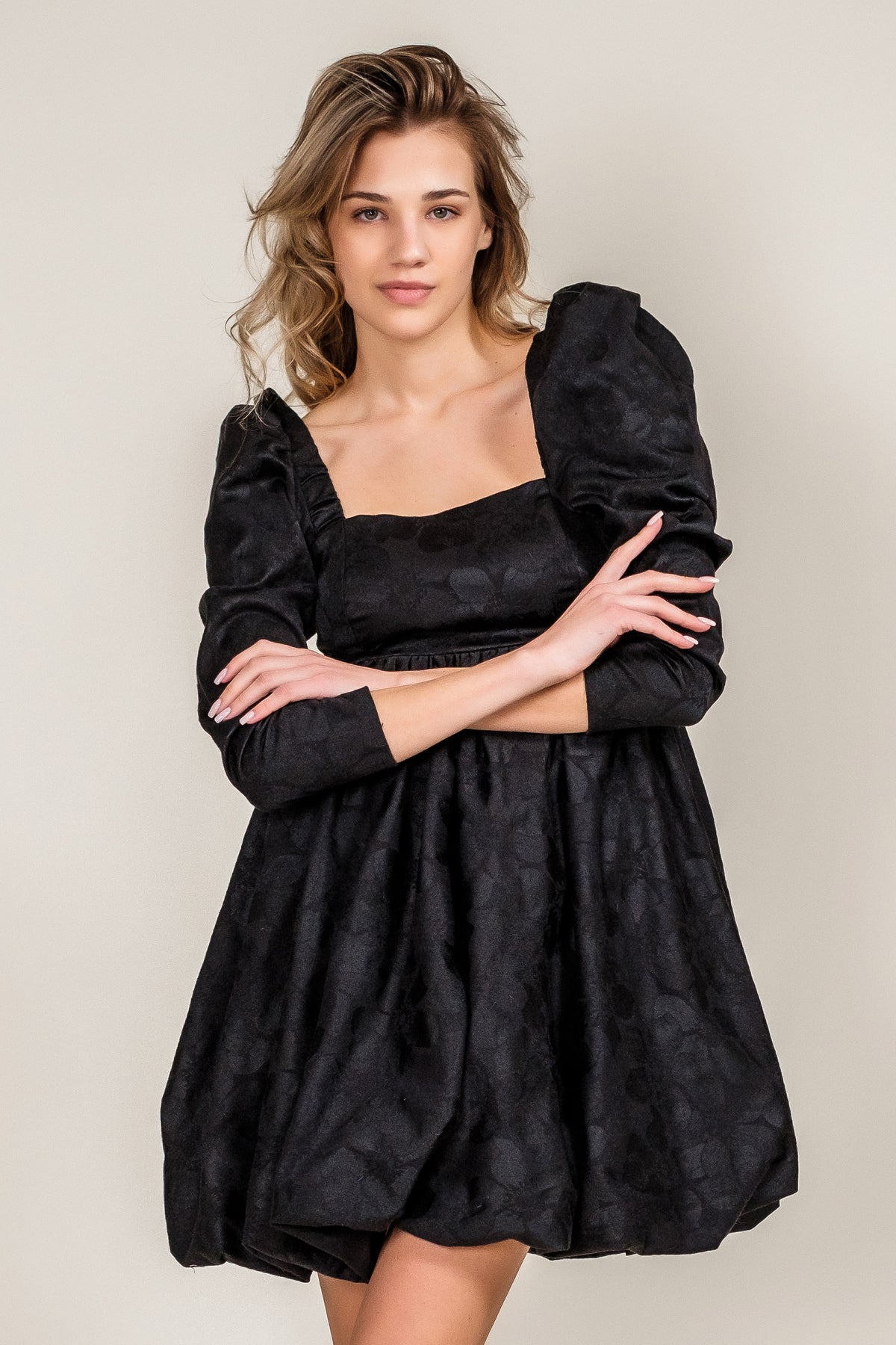 short modern black dress long sleeves high waist open back close up