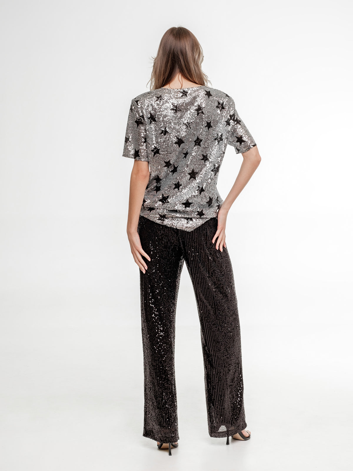silver glitter top with stars and black glitter wide pants occasion wear back view