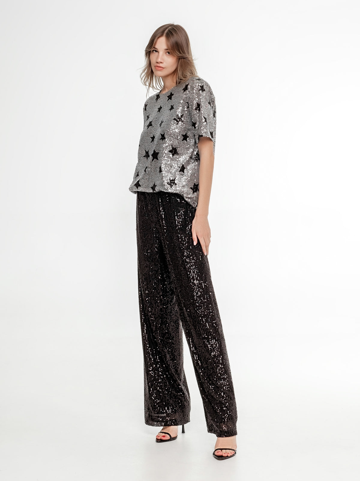 silver glitter top with stars and black glitter wide pants occasion wear
