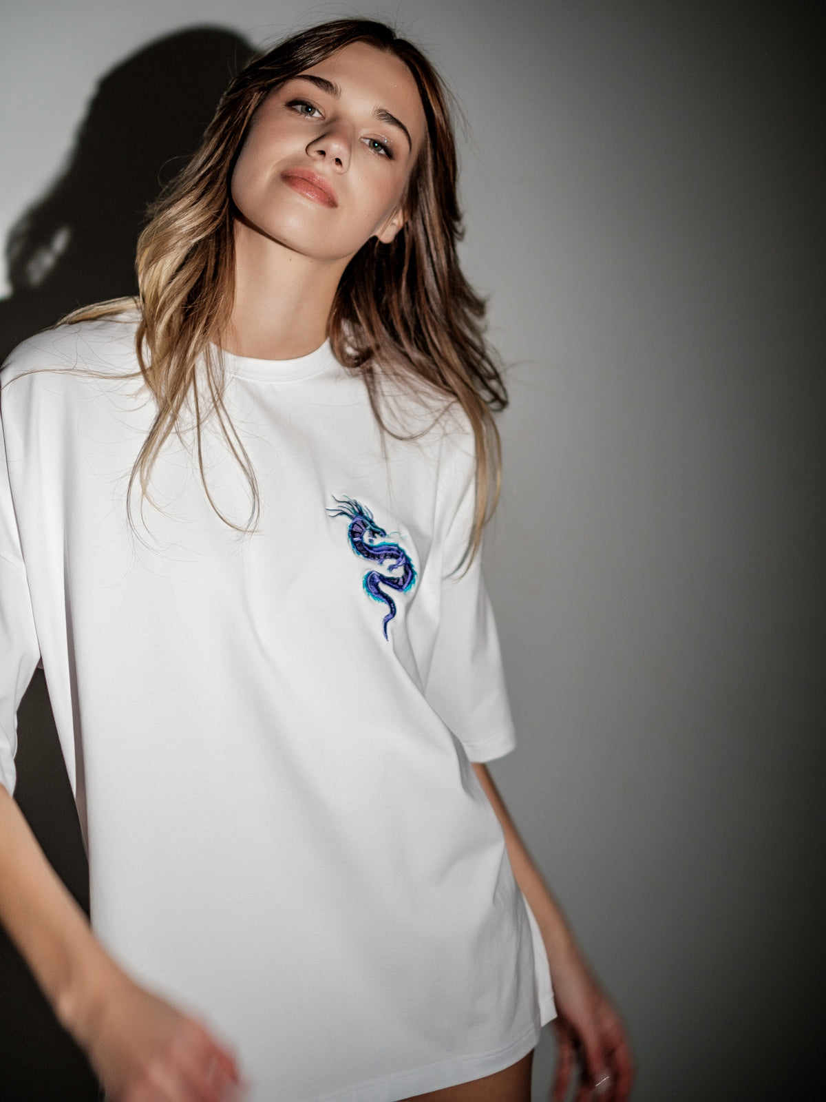 white T-shirt with dragon on the model