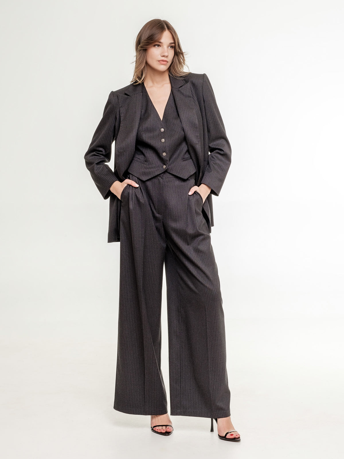 woman 3 piece suit dark grey wide fit jacket and wide trousers view from the side