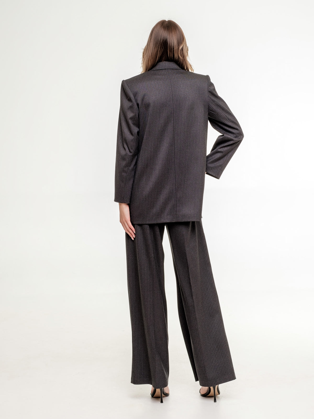 woman suit dark grey wide fit jacket and wide trousers view from the back